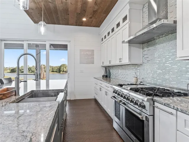 a bedroom with a large bed and a chandelier