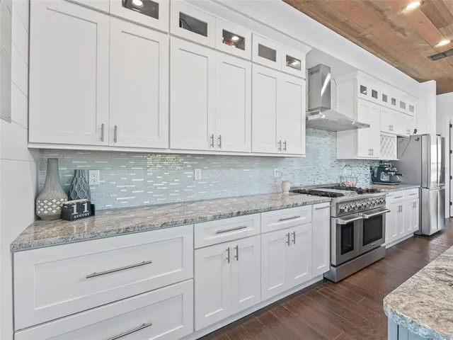 a spacious bathroom with double vanity and a mirror