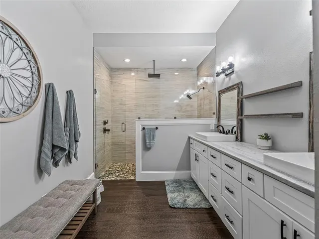 a bathroom with a double vanity sink mirror and toilet