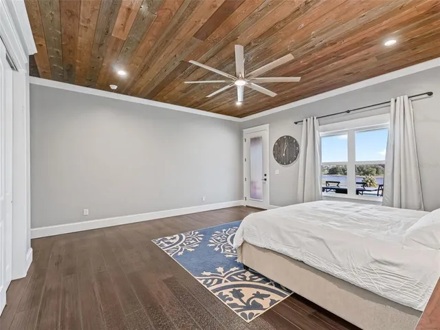 a bathroom with a double vanity sink a toilet a mirror and shower