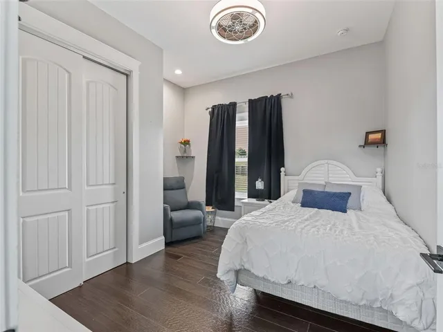 a living room with furniture and a painting on the wall