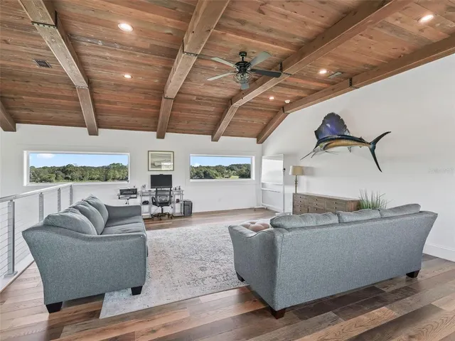 a dining room with furniture and wooden floor