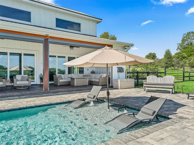 an aerial view of a golf course with a lake view