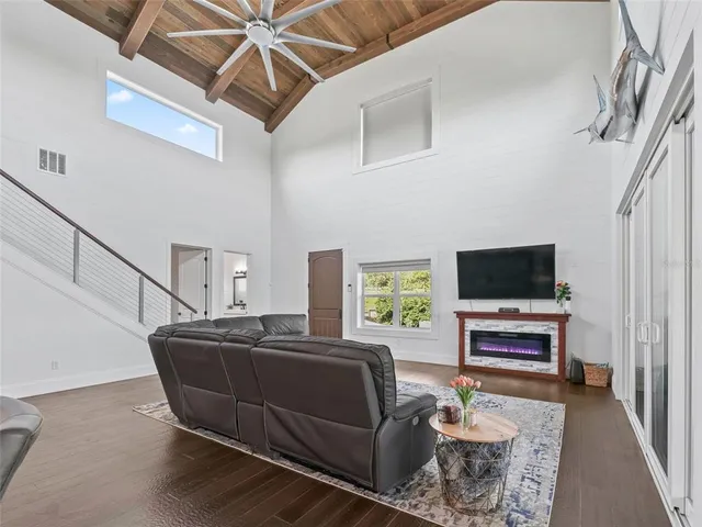 a kitchen with stainless steel appliances granite countertop a table chairs sink and cabinets