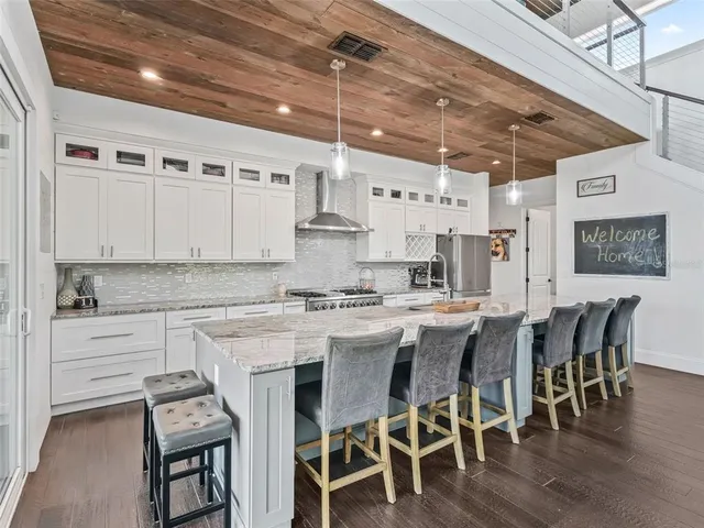 a kitchen with counter top space and wooden floor