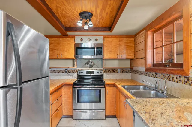 a kitchen with stainless steel appliances granite countertop a stove and a sink
