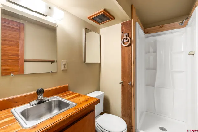 a view of a room with wooden floor and windows