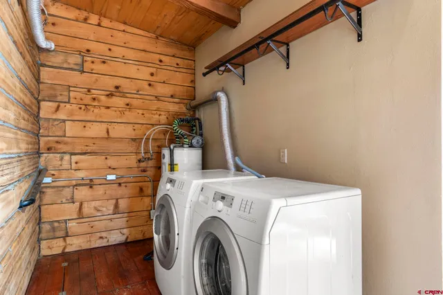 a view of a yard with a table and chairs under an umbrella
