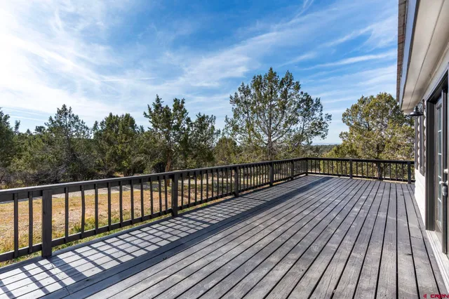 a backyard of a house with a garden and deck
