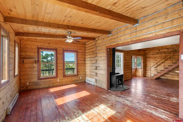 a view of a porch with wooden floor and fence