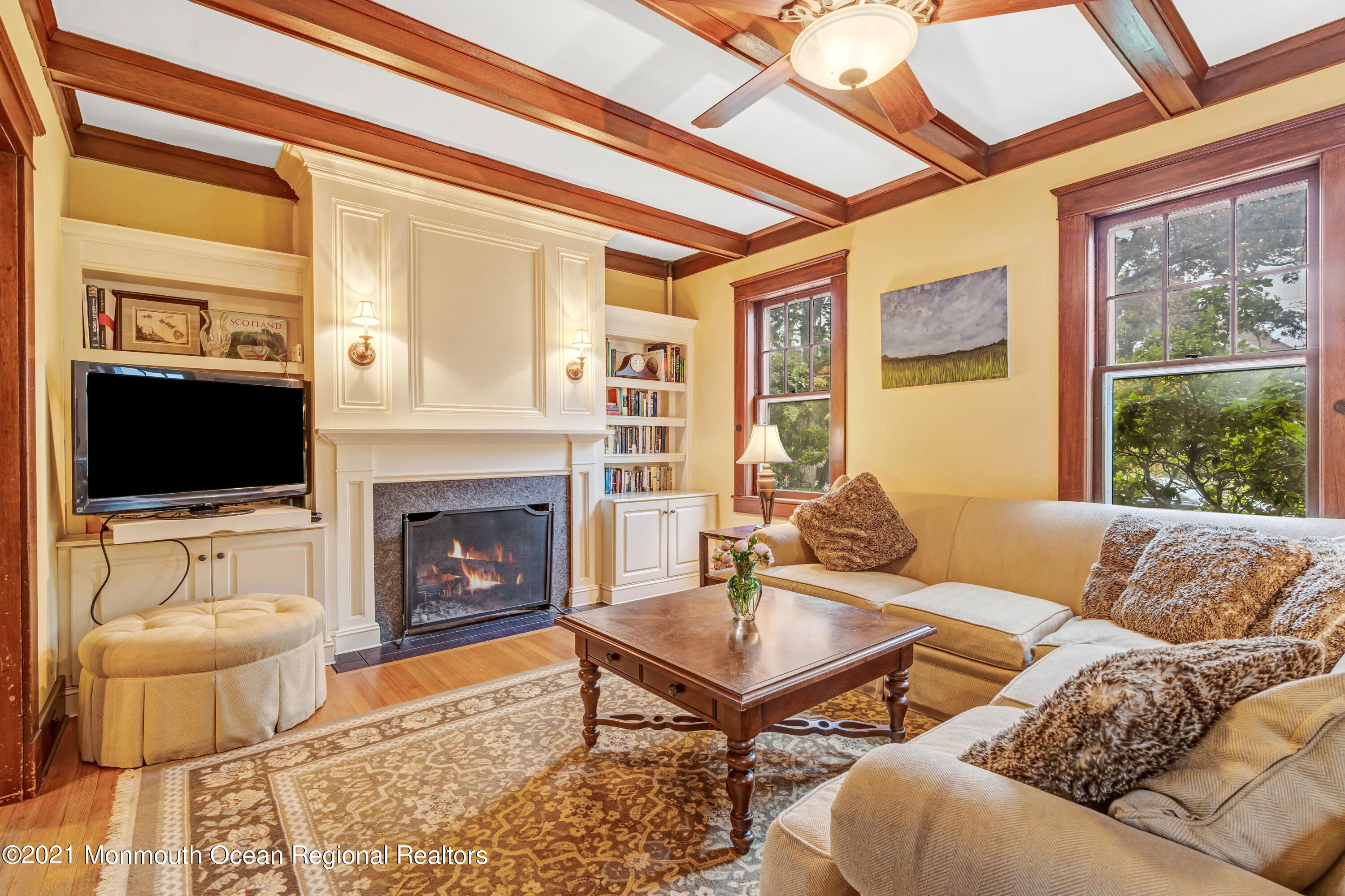 119 Pinckney Road Little Silver, NJ 07739 - Photo 5 of 40 a living room with furniture a flat screen tv and a fireplace