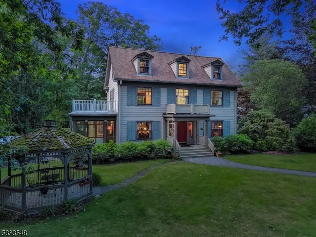 a view of a house with a big yard and potted plants