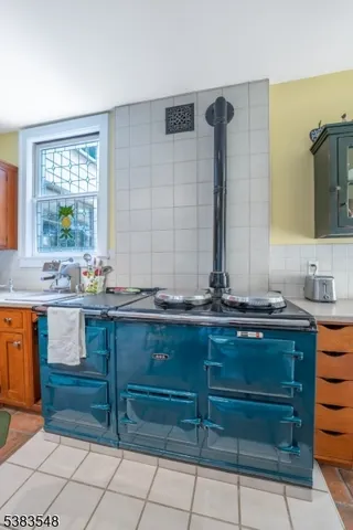 a bathroom with a granite countertop sink and a large mirror