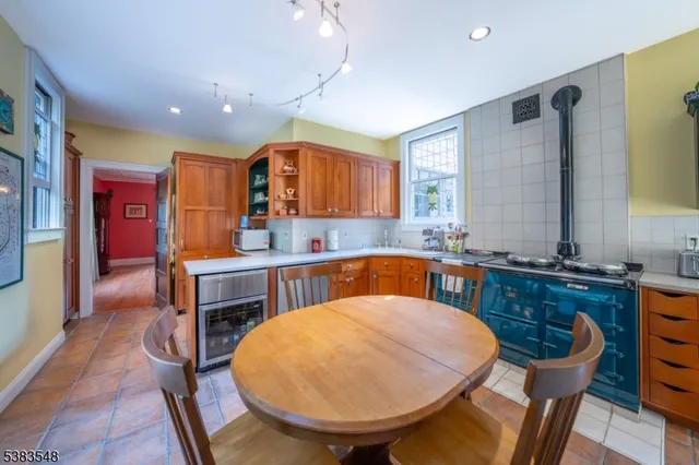 a kitchen with a table chairs sink and cabinets