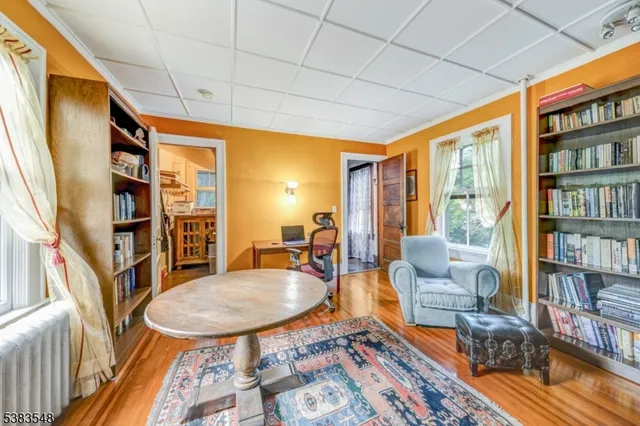 a living room with furniture a rug and a book shelf