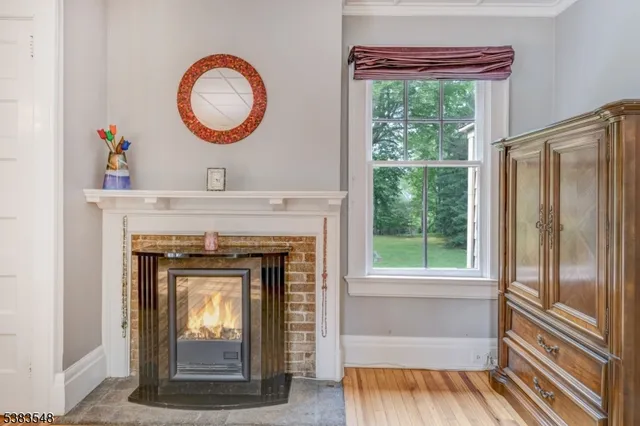 a living room with a fireplace and a window