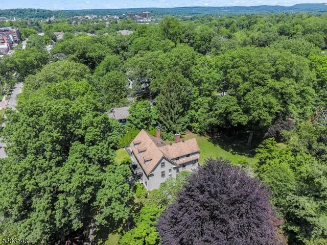 an aerial view of a house with outdoor space and street view