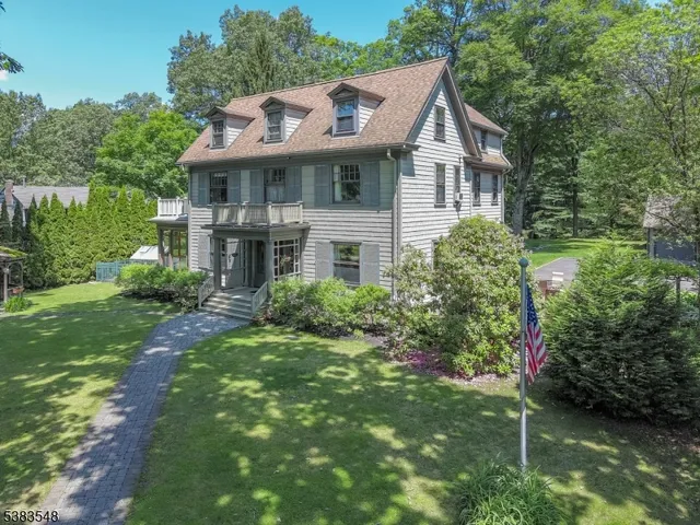 a front view of a house with a yard and green space