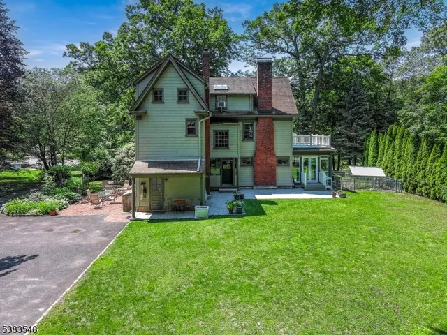 a front view of a house with a yard and trees