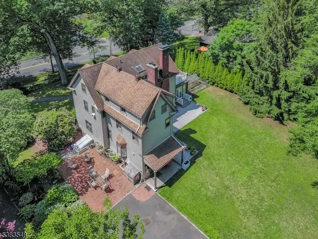 an aerial view of a house with a big yard