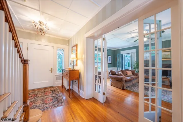 a view of a livingroom with furniture wooden floor and windows