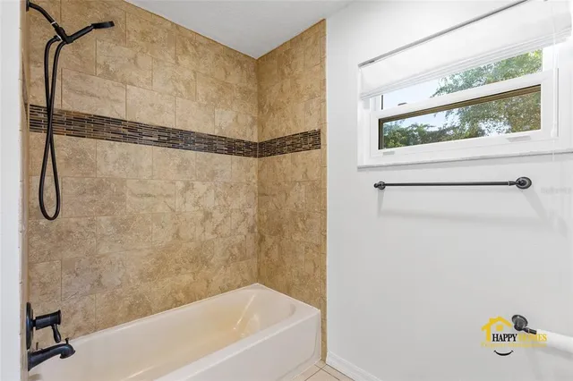 an empty room with couch and wooden floor