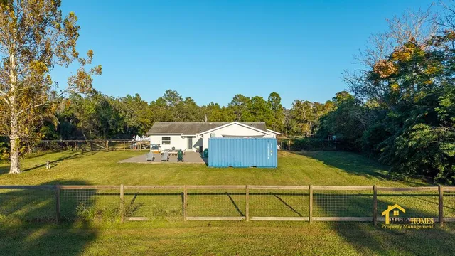 a view of swimming pool with large trees