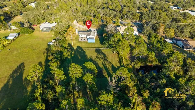 a view of a yard with table and chairs and wooden fence