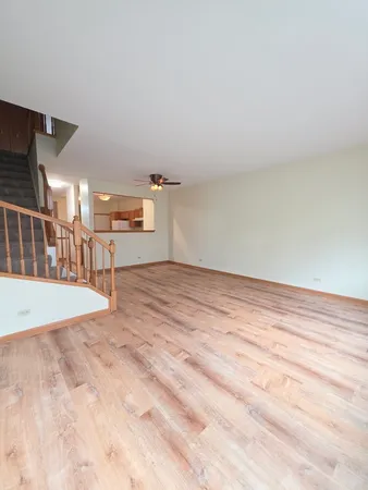 a view of a livingroom with kitchen and a window