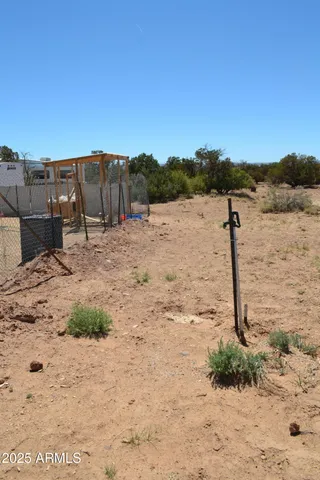 a view of roof deck with table and chairs a barbeque with wooden fence