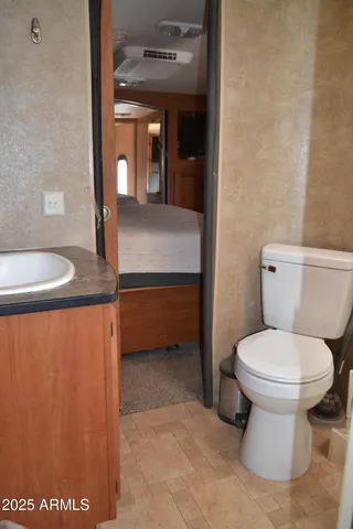 a bathroom with a toilet sink and mirror