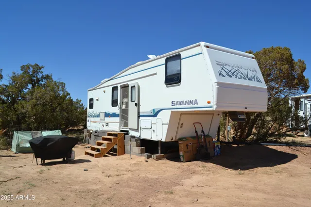 a view of a dry yard with mountains in the background