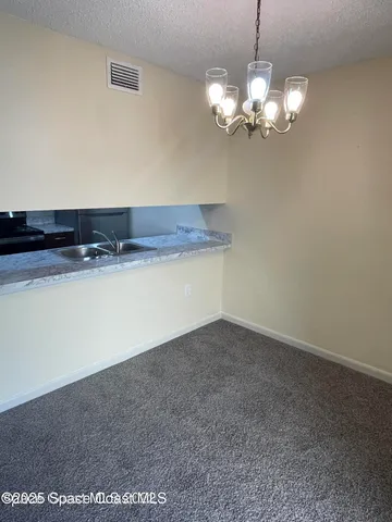 a view of a livingroom with a chandelier fan