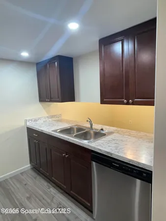 a kitchen with granite countertop wooden cabinets and a granite counter tops