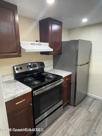 a stove top oven sitting inside of a kitchen