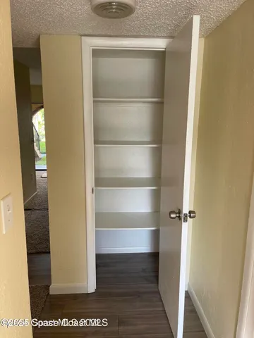 a view of walk in closet with empty racks