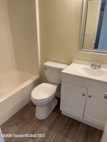 a bathroom with a sink a toilet and bathtub