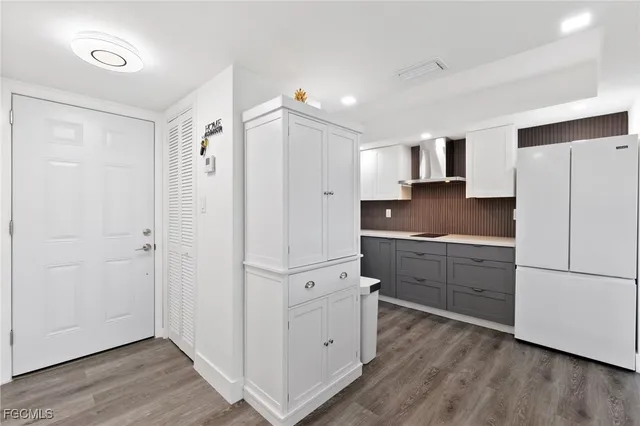 a kitchen with white cabinets and white appliances