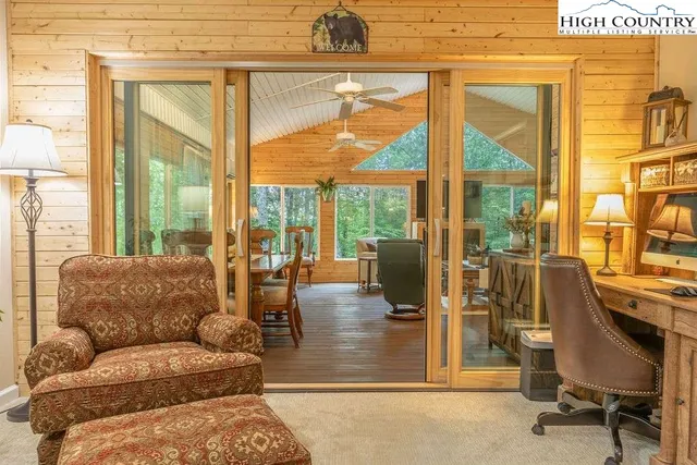 a living room with furniture and a floor to ceiling window