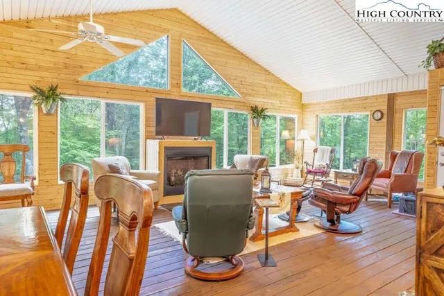 a living room with furniture and floor to ceiling windows