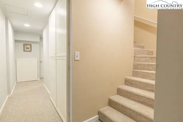 a view of staircase with white walls