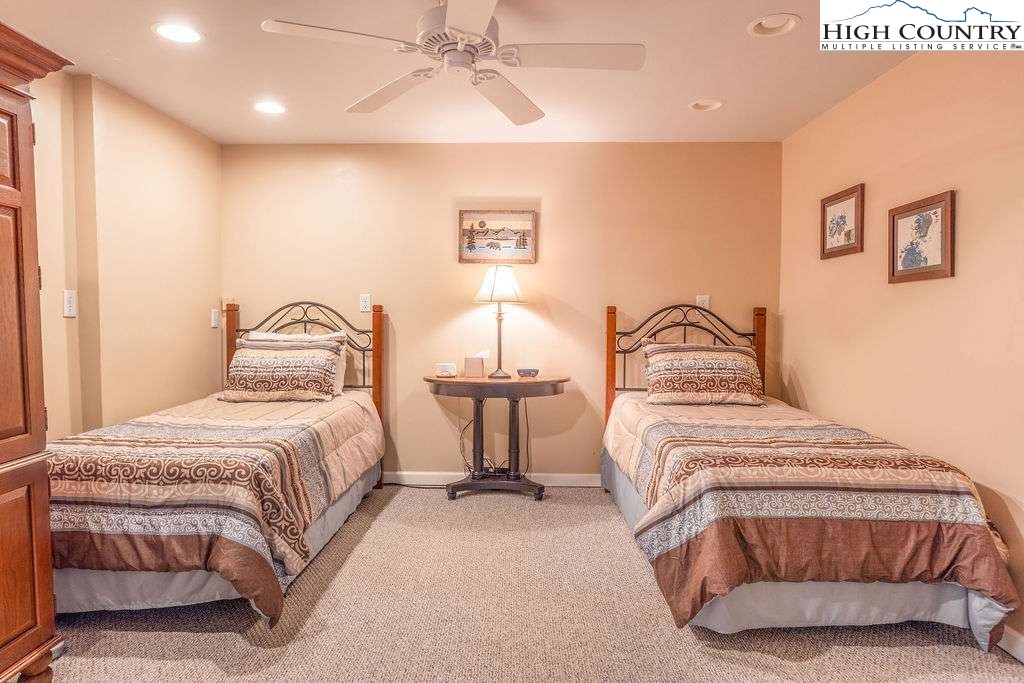 120 Ridge Road Newland, NC 28657 - Photo 19 of 40 a bedroom with a bed and lamp