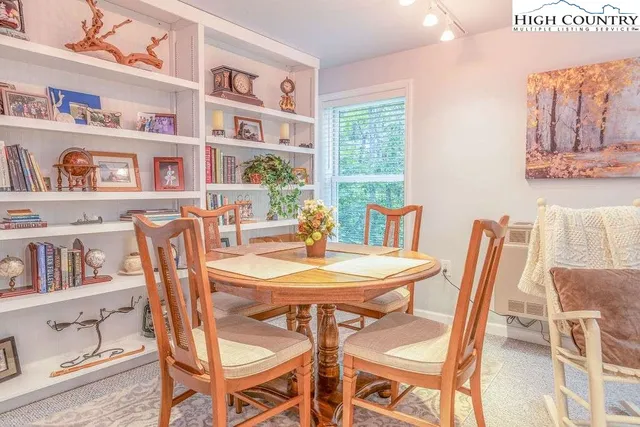 a dining room with furniture and a book shelf