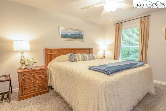 a bedroom with a bed and a lamp