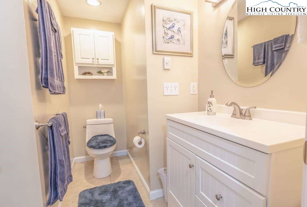 120 Ridge Road Newland, NC 28657 - Photo 26 of 40 a bathroom with a sink toilet a mirror and vanity