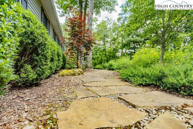 a view of a pathway both side of a yard