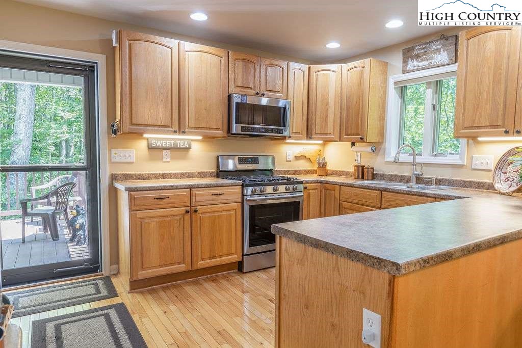 120 Ridge Road Newland, NC 28657 - Photo 3 of 40 a kitchen with stainless steel appliances granite countertop a stove a sink and a microwave