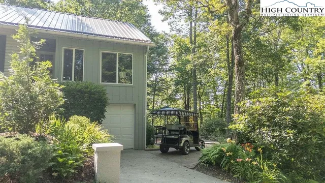 a view of a chair and table in front of house