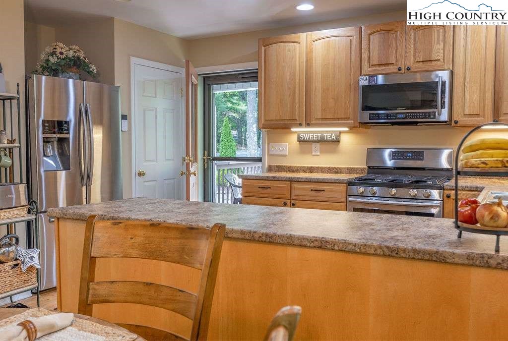 120 Ridge Road Newland, NC 28657 - Photo 4 of 40 a kitchen with stainless steel appliances granite countertop a refrigerator a stove top oven a sink and dishwasher