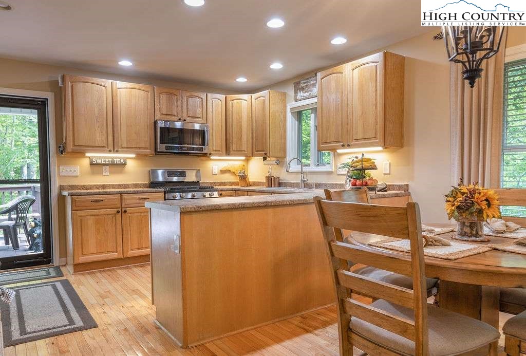 120 Ridge Road Newland, NC 28657 - Photo 5 of 40 a kitchen with kitchen island granite countertop a sink cabinets and stainless steel appliances